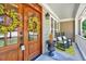 Close-up of a charming front porch with rocking chairs, double-door entrance, and decorative accents at 44 Grandwood Cir, Durham, NC 27712