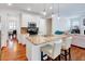 Open-concept kitchen features granite countertops, stainless steel appliances, and seamless flow to the living area at 44 Grandwood Cir, Durham, NC 27712