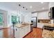Modern kitchen with an island, stainless steel appliances, hardwood floors and an adjacent breakfast nook at 44 Grandwood Cir, Durham, NC 27712