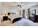 Spacious main bedroom with a ceiling fan and beautiful natural lighting at 44 Grandwood Cir, Durham, NC 27712