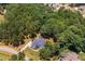 Aerial view of a beautiful home surrounded by lush greenery and mature trees in a private setting at 45 Calabria Ct, Clayton, NC 27527
