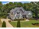 Beautiful home with a manicured lawn, mature trees and a circular driveway providing ample parking at 45 Calabria Ct, Clayton, NC 27527