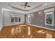 Spacious bedroom with wood floors, natural light, tray ceiling, and chandelier lighting at 45 Calabria Ct, Clayton, NC 27527