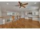 Bright bonus room features hardwood floors, built-in shelving, desk, and a ceiling fan at 45 Calabria Ct, Clayton, NC 27527