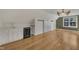 Bonus room with bar featuring a sink, wine fridge, white cabinets, and wood floors at 45 Calabria Ct, Clayton, NC 27527