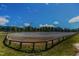 Equestrian arena with well-maintained sand, bordered by a wooden fence and trees at 45 Calabria Ct, Clayton, NC 27527