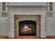 Cozy fireplace with stone surround and custom mantel creating a warm and inviting focal point at 45 Calabria Ct, Clayton, NC 27527