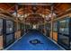 Interior view of a horse barn with stalls on either side of the aisle, well-lit and maintained at 45 Calabria Ct, Clayton, NC 27527