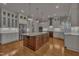 Spacious kitchen with granite countertops, large island, stainless steel appliances, and custom cabinetry at 45 Calabria Ct, Clayton, NC 27527