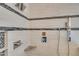 Modern shower with gray and white tile, a shower head, and soap and shampoo caddy at 45 Calabria Ct, Clayton, NC 27527