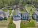 Aerial view of a home featuring a spacious yard, fenced play area, and long driveway at 49 Everwood Dr, Four Oaks, NC 27524