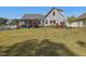 Beautiful backyard features mature trees, a well-kept lawn, and a covered patio perfect for outdoor living at 49 Everwood Dr, Four Oaks, NC 27524