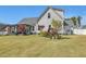 Large backyard features a patio with pergola and luscious landscaping at 49 Everwood Dr, Four Oaks, NC 27524