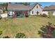 Spacious backyard with mature trees, a manicured lawn, and a covered patio perfect for outdoor entertaining at 49 Everwood Dr, Four Oaks, NC 27524