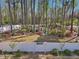 An enchanting backyard garden features mature trees, beautiful landscaping, and a gated entrance to a private space at 49 Everwood Dr, Four Oaks, NC 27524