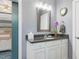 Granite-topped vanity with chrome fixtures is situated adjacent to the bedroom at 49 Everwood Dr, Four Oaks, NC 27524