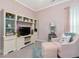 Inviting bedroom offers a built-in shelving unit, soft chair, and accent lamps at 49 Everwood Dr, Four Oaks, NC 27524
