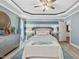Charming bedroom features blue striped walls, tray ceiling, and a door leading to the en suite bathroom at 49 Everwood Dr, Four Oaks, NC 27524