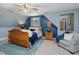 Bedroom with blue walls, window, ceiling fan, and a comfortable bed at 49 Everwood Dr, Four Oaks, NC 27524