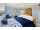 Bedroom with blue walls, window, ceiling fan, and a comfortable bed at 49 Everwood Dr, Four Oaks, NC 27524