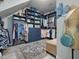 Custom walk-in closet with ample shelving, drawers, and hanging storage for clothes and accessories at 49 Everwood Dr, Four Oaks, NC 27524