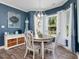 Eat in kitchen with a dining room that features large windows and blue walls at 49 Everwood Dr, Four Oaks, NC 27524