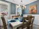 Bright dining room with a white table, comfortable chairs, and large windows with decorative curtains at 49 Everwood Dr, Four Oaks, NC 27524