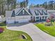 A beautiful two-story home with a three-car garage and a long, curved driveway at 49 Everwood Dr, Four Oaks, NC 27524