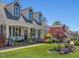 Charming two-story home with dormer windows, lush landscaping, and inviting front porch at 49 Everwood Dr, Four Oaks, NC 27524