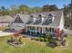 Two story home with a three car garage, covered porch and manicured lawn at 49 Everwood Dr, Four Oaks, NC 27524