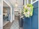 Inviting foyer with a decorative wreath, wood floors, and a glimpse into the well-lit living spaces at 49 Everwood Dr, Four Oaks, NC 27524