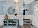 Stylish foyer featuring a light blue console table, a round mirror, and elegant wall sconces at 49 Everwood Dr, Four Oaks, NC 27524