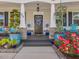 Charming front porch adorned with colorful flowers and greenery, leading to the welcoming front door at 49 Everwood Dr, Four Oaks, NC 27524