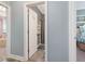 Hallway view showcases an open door leading to a bathroom with tile flooring at 49 Everwood Dr, Four Oaks, NC 27524