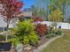 Artistic landscaping features Japanese Maple trees, perennials, and a stone pagoda at 49 Everwood Dr, Four Oaks, NC 27524