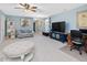 Open living area featuring modern decor, large TV, and a comfortable seating arrangement at 49 Everwood Dr, Four Oaks, NC 27524