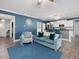 Open living space connecting to a kitchen, featuring stylish seating and contemporary design at 49 Everwood Dr, Four Oaks, NC 27524