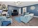 Inviting living room with fireplace, blue accents, and hardwood floors at 49 Everwood Dr, Four Oaks, NC 27524