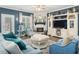 Comfortable living room with a fireplace, entertainment center, and stylish blue decor at 49 Everwood Dr, Four Oaks, NC 27524