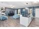 Open-concept living area with kitchen island, comfortable seating, and cozy fireplace at 49 Everwood Dr, Four Oaks, NC 27524
