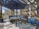 Outdoor dining space with seating, umbrella, and pergola at 49 Everwood Dr, Four Oaks, NC 27524