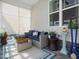 Comfortable screened patio with stylish blue furniture and decor at 49 Everwood Dr, Four Oaks, NC 27524