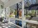 Views of the landscaped backyard from the screened patio through large windows at 49 Everwood Dr, Four Oaks, NC 27524