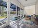 Screened porch with pergola, stylish furnishings and outdoor seating at 49 Everwood Dr, Four Oaks, NC 27524