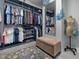 Well-organized walk-in closet boasts ample storage space, mirror, and bench at 49 Everwood Dr, Four Oaks, NC 27524