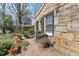 Unique stone exterior with green shutters, showing a view of the patio and garden area around the house at 4914 Western Blvd, Raleigh, NC 27606