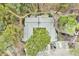Aerial view of a home surrounded by lush trees with a spacious deck and private driveway at 500 W Woodcroft Pkwy, Durham, NC 27713