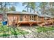 Backyard with a wooden deck, stone landscaping, and a well-maintained lawn at 500 W Woodcroft Pkwy, Durham, NC 27713