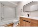 Updated bathroom with a modern vanity, mirror, and tiled shower-tub combination at 500 W Woodcroft Pkwy, Durham, NC 27713