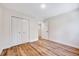 Bedroom featuring hardwood floors, closet, and ample natural light at 500 W Woodcroft Pkwy, Durham, NC 27713